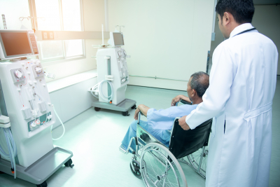 doctor assisting patient to a room with medical equipments